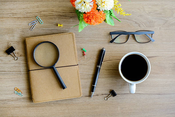 istock Cup of coffee with notebook on desk 477872598
