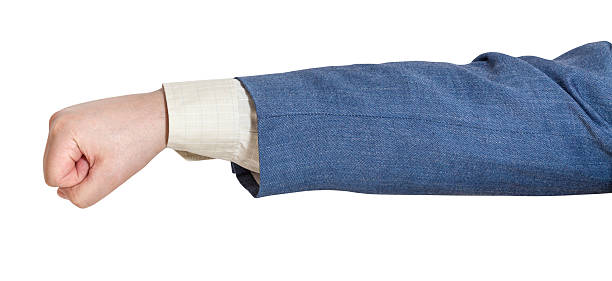 istock hand gesture - man in business suit punches 477872844