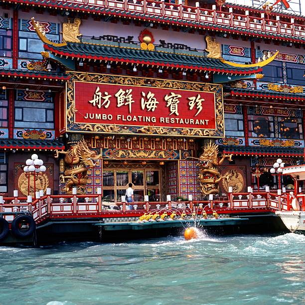 Jumbo floating restaurant, Hong Kong. Hong Kong, China - October 17, 1991: Jumbo floating Chinese restaurant in Aberdeen harbour with a person walking past the door, Aberdeen, Hong Kong, China aberdeen hong kong photos stock pictures, royalty-free photos & images