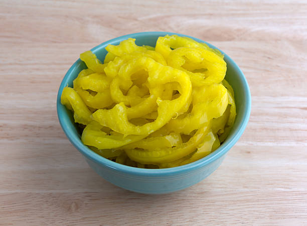 istock Banana peppers in a bowl on a wood table 477873442