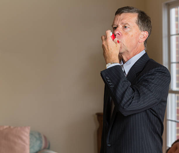 istock Senior businessman with asthma inhaler 477879478