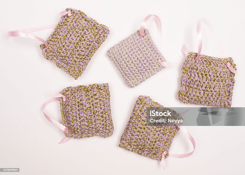 Crocheted Bags with Dried Lavender Crocheted bags with dried lavender isolated on white. Alternative Medicine Stock Photo