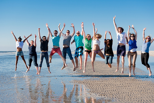 Twelve young people jumping at the beach of St.Peter-Ording in Germany. Image taken with Canon EOS 1Ds Mark 2 and EF 70-200 mm USM L 2,8.