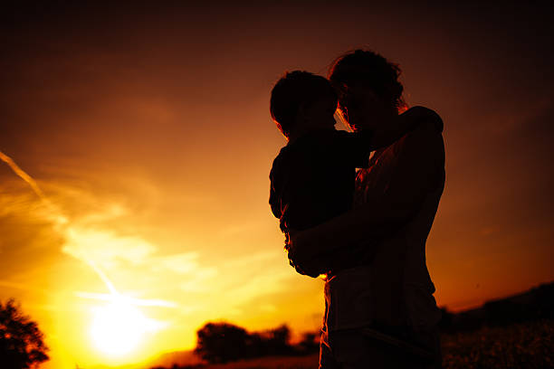 istock Mother and son enjoying the sunset 477883874