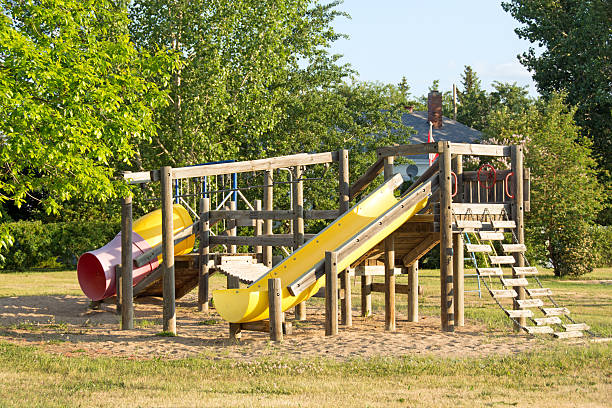 istock Older rural community playground equipment including slides 477884910