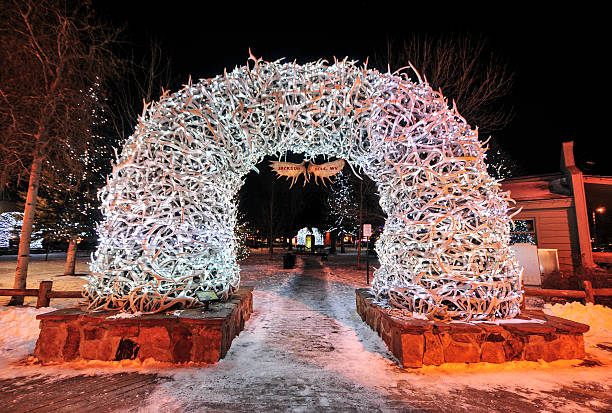 Antler Arches on Jackson Hole Square, Wyoming Large elk antler arches curve over Jackson Hole's square's four corner entrances. The antlers have been there since the early 1960s, and new arches are currently assembled to replace them. Lit up at night for Christmas-time. jackson hole photos stock pictures, royalty-free photos & images