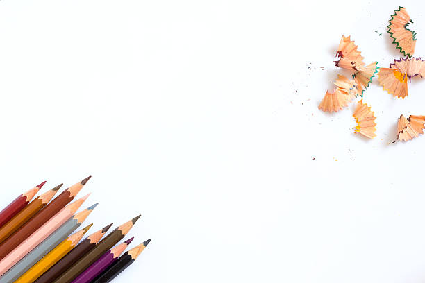 istock multicolored pencils growing row and pencil shaves on white background 477885720