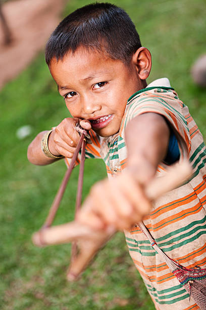istock Young boy with slinghshoot in Northern Laos 477886271