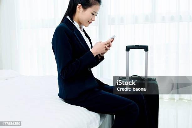 Businesswoman Texting Message At Hotel Room Stock Photo - Download Image Now - 2015, Adult, Adults Only