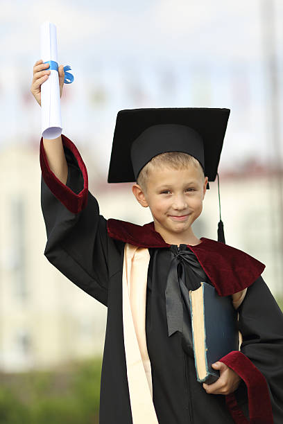 istock Boy graduate with a diploma and books 477887269