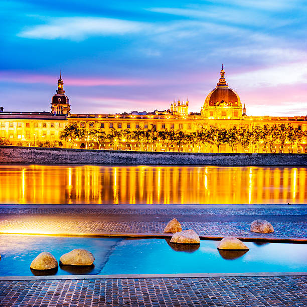 Lyon by sunset in summer night view from Rhone river in Lyon city with Hotel Dieu and Fourviere cathedral, France fourviere stock pictures, royalty-free photos & images