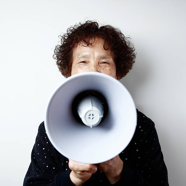 istock The old woman and the speaker 477888095