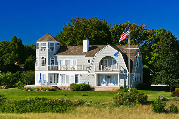Luxury Home in Hyannis, Cape Cod, Massachusetts, USA, lit by morning sun. The house is situated next to Lewis Bay Light.