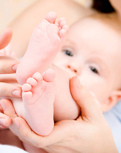 istock baby's foot in mother hands 477889622