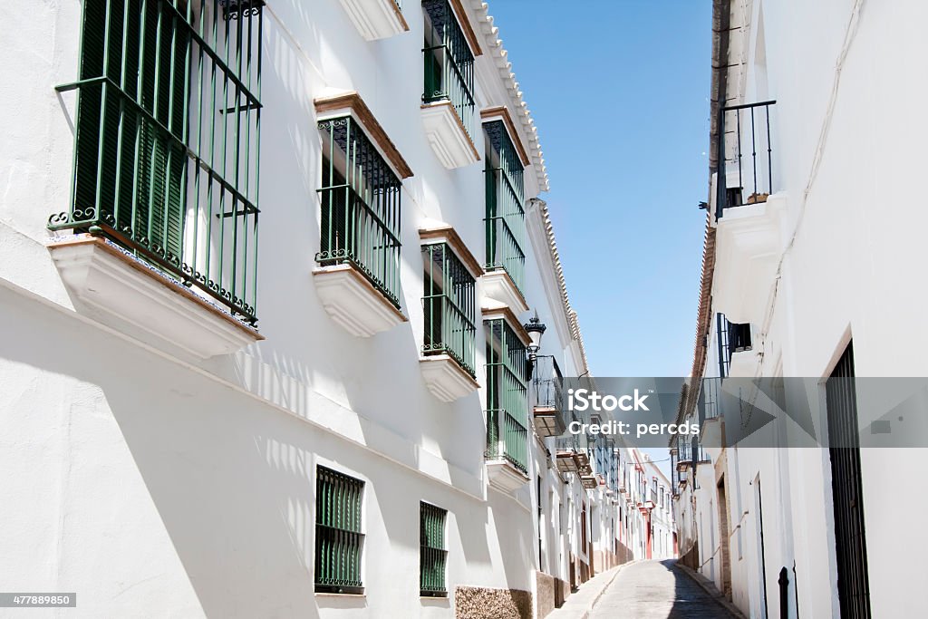 White narrow street in Carmona, Seville province, Spain. White narrow empty street a sunny day in Carmona, Seville province, Andalucía, Spain.  2015 Stock Photo
