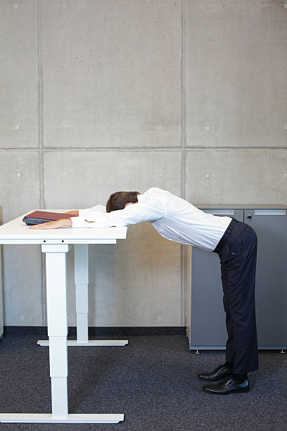 istock yoga in office. business man exercising at workplace 477889900