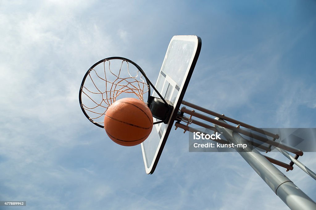 Basket ball in the hoop basketball game, outdoor Basketball - Sport Stock Photo