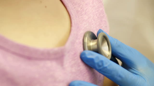 Nurse Gives Young Girl Checkup with Stethoscope