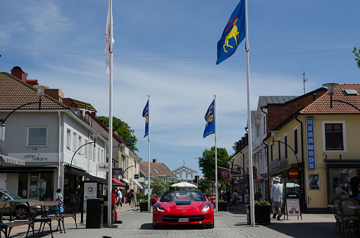 Borgholm, Sweden - June 13, 2015: Chevrolet Corvette parade at the Club Corvette Sweden summer meeting 2015 in the town of Borgholm at the island Oland in Sweden. In front of the parade at this image from the main street in Borgholm is a red 2014 Corvette C7.  