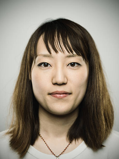 Portrait of a young japanese woman looking at camera stock photo