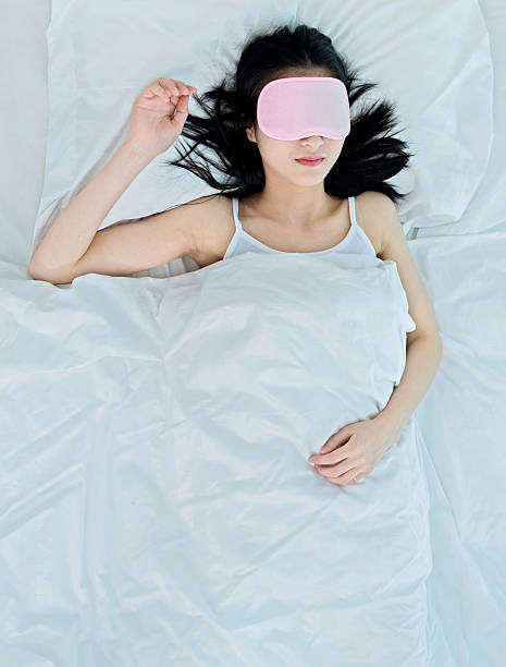 istock woman sleeping in sleep mask 477893090