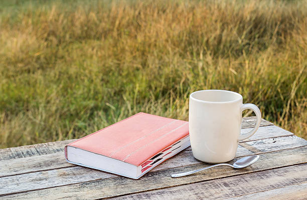 istock notebook and coffee cup on wood background 477893360