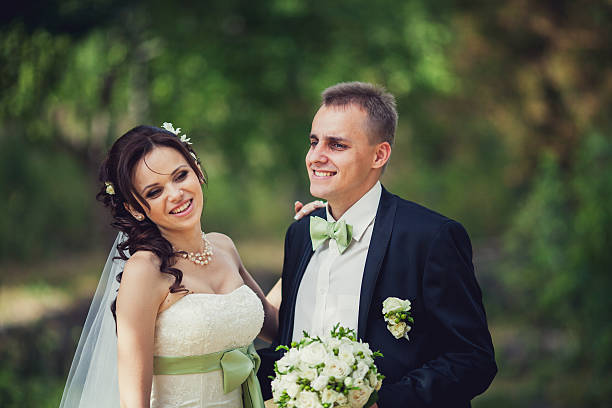 istock wedding. bride and groom embracing against the backdrop 477895895