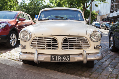 Helsinki, Finland - June 13, 2015: Old white Volvo Amazon 121 B12 car is parked on the roadside in Helsinki