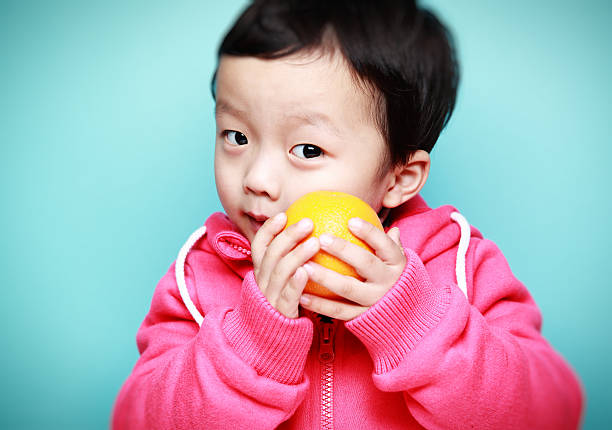 Cute asia children Cute asia children valencia orange photos stock pictures, royalty-free photos & images