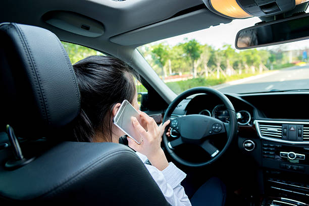 istock Asian woman driving a car and calling 477898406