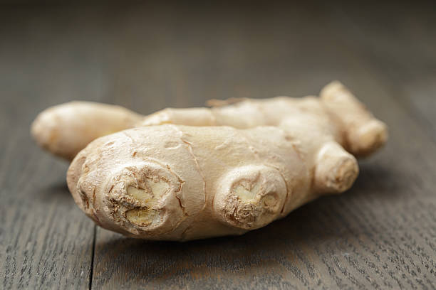 istock big piece of ginger root on wooden table 477898678