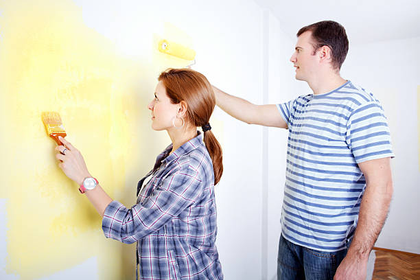 istock Happy couple painting a wall. 477898767