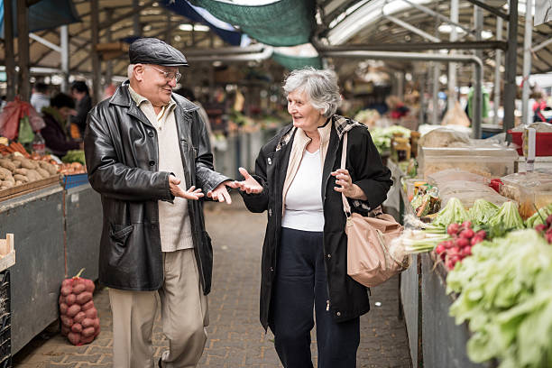 istock Happy senior couple walking through market and communicating. 477903786