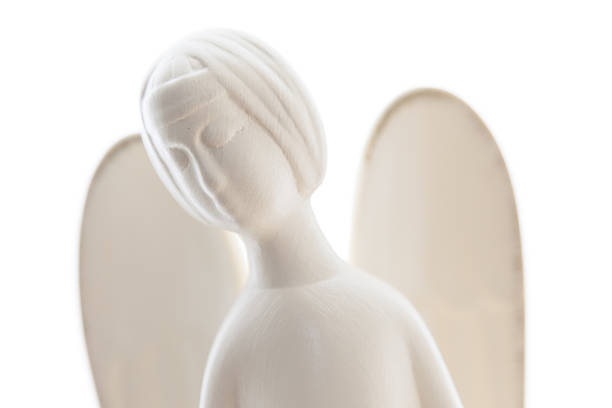 Soft macro shoot of angel statue made of clay with isolated background.