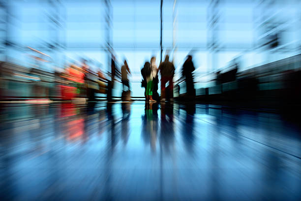 istock Zoom blurred airport terminal, travellers in silhouette 477907985