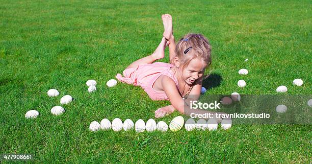 Little Happy Girl Playing With Easter Eggs On Green Grass Stock Photo - Download Image Now