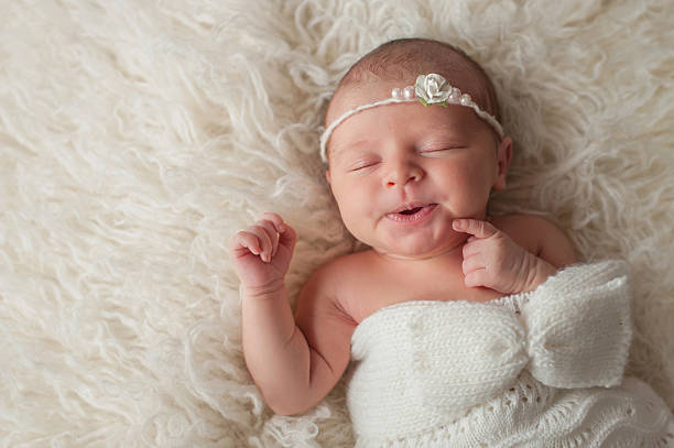 Baby Girl Wearing a White Knitted Bonnet stock photo