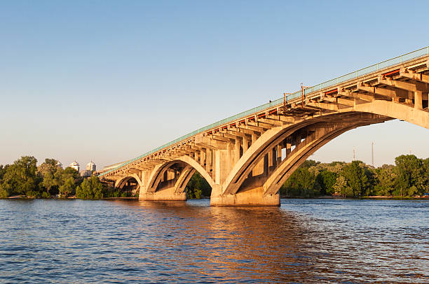istock Concrete bridge across a river at sunset 477910309