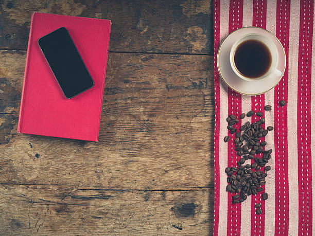 istock Coffee concept with cup, a book and a smart phone 477913492