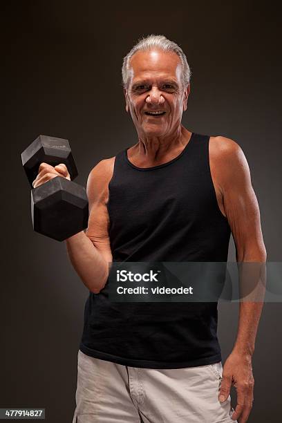 Portrait Of A Senior Man Exercising With Dumbbell Stock Photo - Download Image Now - Dumbbell, Senior Men, Studio Shot