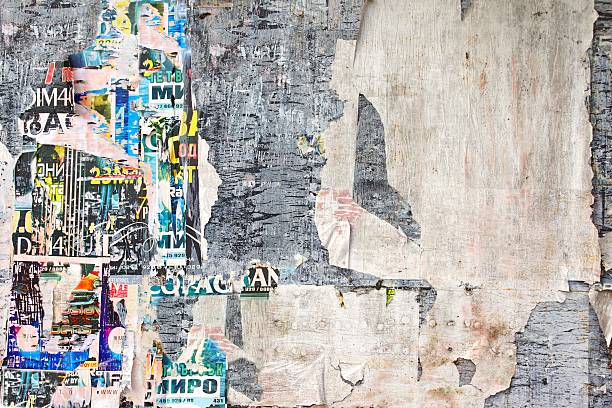 istock Old Weathered Wood Billboard with Torn Posters 477918944