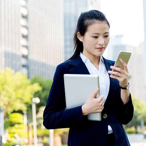 istock Asian businesswoman using smart phone 477920704