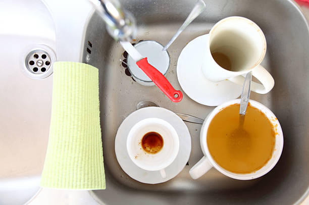 istock Dishwashing. White dishes in the kitchen sink. 477923649