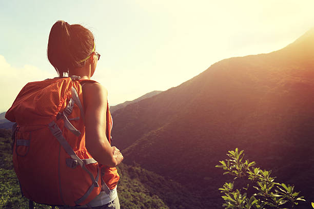 istock woman backpacker enjoy the view at mountain peak 477926018