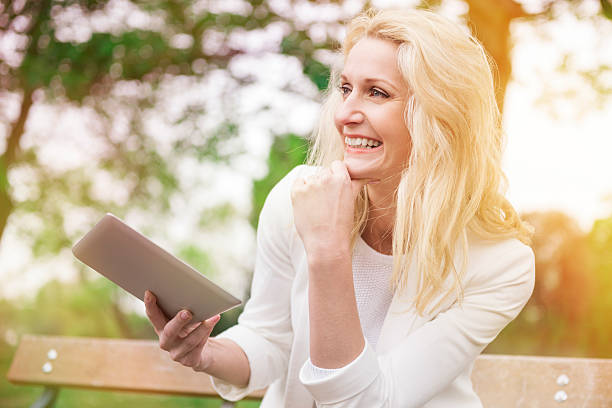 istock Enjoying the wireless Internet even in the park 477926058