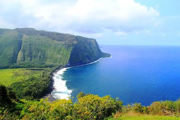 Beautiful natural scenery of Hawaii, steep hill and cliff down to the sea. Epic natural panorama and scenery of Hawaii.