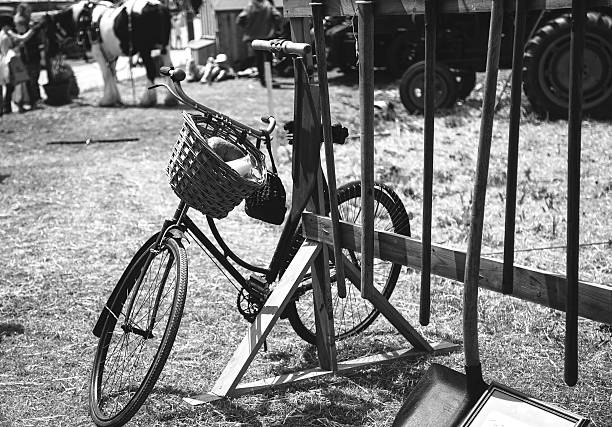 Old bike resting againt some old farming tools