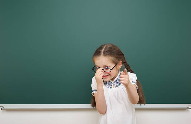 istock Schoolgirl near school board 477932018
