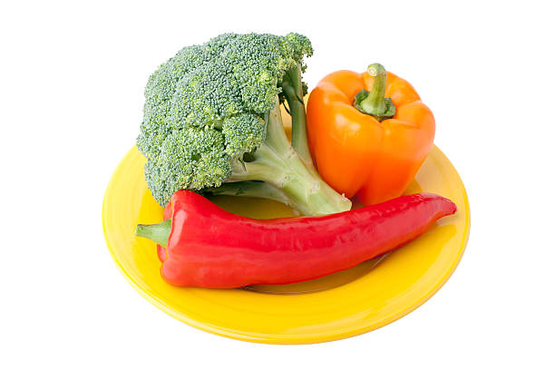 Sweet red and orange bell pepper yellow plate on a white background