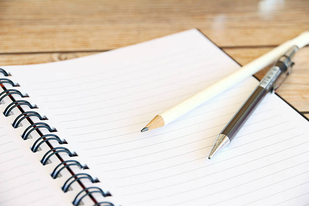 istock Open sketchbook and a pencil on the wooden table 477934306